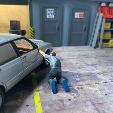 1-43 garage diorama figurine of a mechanic removing a wheel with a wrench