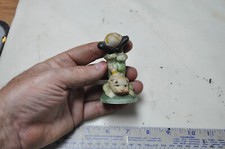 Vintage Clown Standing on His Head in Green Outfit, holding a Ball with his feet