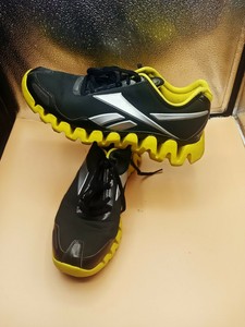 black and yellow reebok zigtech