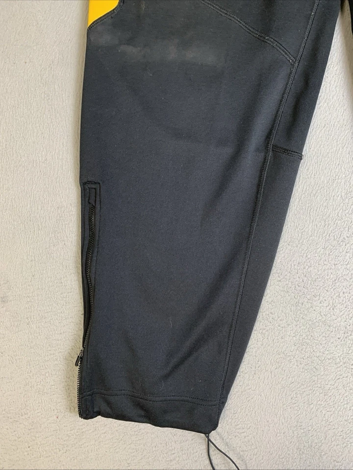 Pantalones de chándal Nike Dri-Fit para hombre talla grande negros y amarillos con cremallera al tobillo Foto 4 de 4