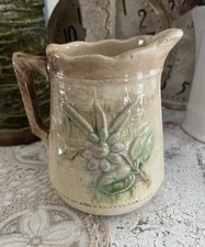 Majolica ceramic creamer with basketweave pattern and floral design