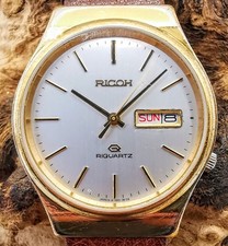 VINTAGE RICOH RIQUARTZ GOLD TONE WRISTWATCH, NEW BATTERY, BRAND NEW CRYSTAL HAS