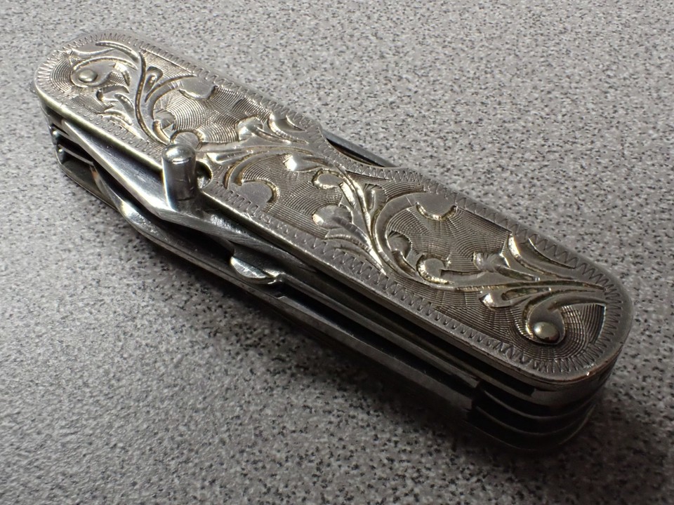 Sterling silver, floral-engraved, 8-tool Japanese pocket knife — an heirloom-quality antique multitool that looks more like jewelry than hardware.
