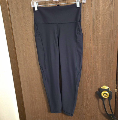 Athleta Interval Stash 7/8 Tight Black  Capri Leggings Pockets Logo Women's S