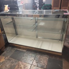 Retail Display Case. Glass Shelves. Doors Intact. Fair Condition. Used.
