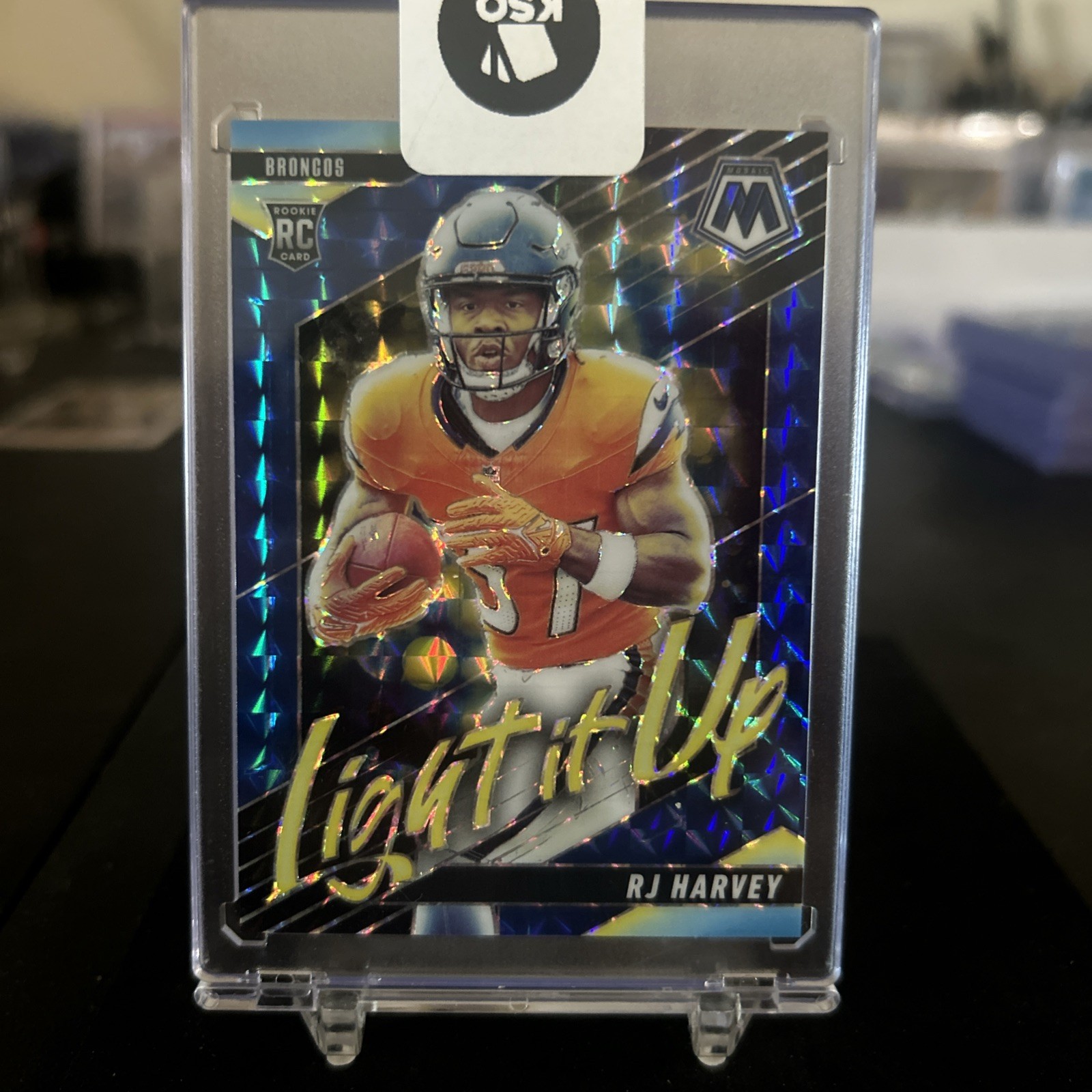 2025 Panini Mosaic - Light It Up Mosaic RJ Harvey #18 Blue Prizm /99 (RC)