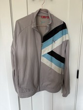 vintage-look PUMA track jacket in gray with blue, black, and white accents