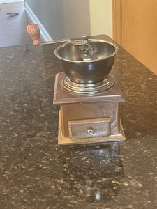 Vintage manual coffee grinder with a vintage, hand-crank style