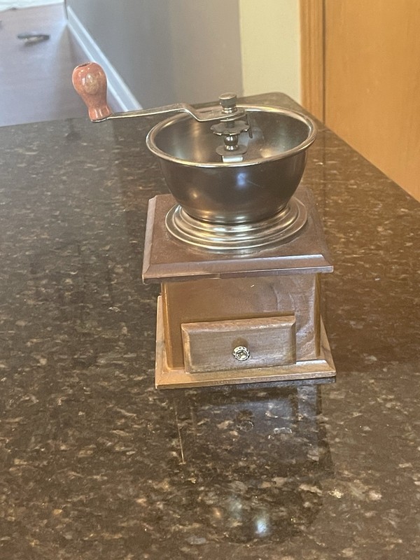 Vintage manual coffee grinder with a vintage, hand-crank style