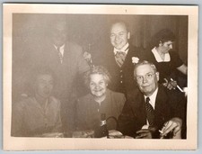 Vtg B&W Snapshot Group At Table Smiling Gathering 1950s