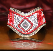 Handmade cuff bracelet features intricate red...
