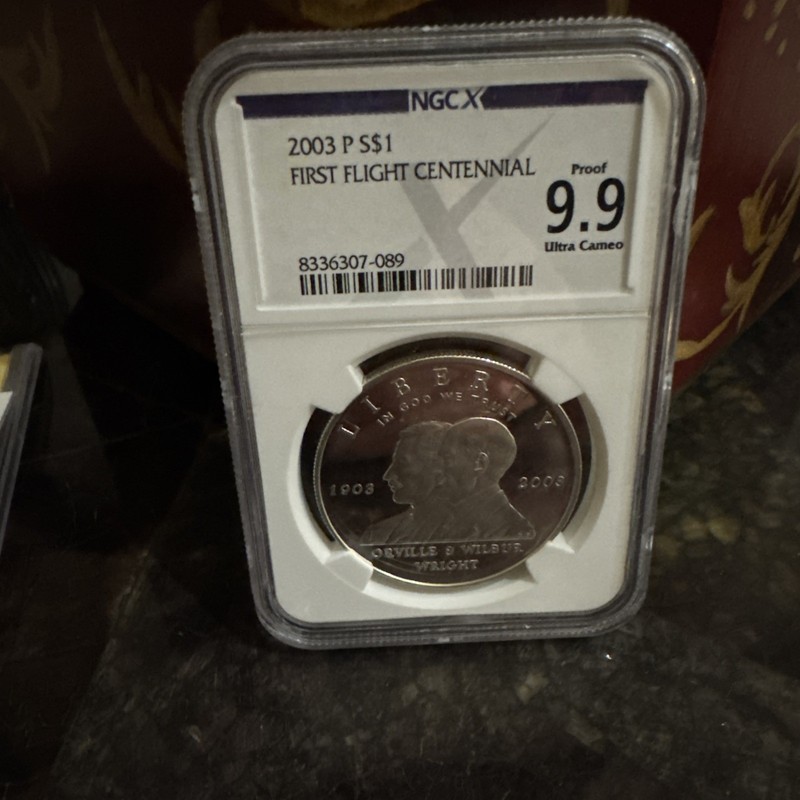 Proof 9.9 UCam 2003-P First Flight Commemorative Dollar NGC X