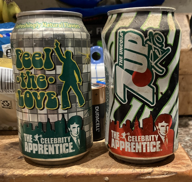 7UP Lot of 2 Promo Soda Cans "Feel the 7UP" Celebrity Apprentice Graphics