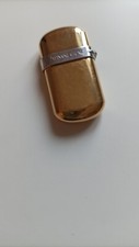 briquet Yves Saint Laurent plaqué or serti d'un saphir numéroté 028256