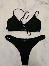 Women's 2 piece solid black bikini ties up in the back size large.