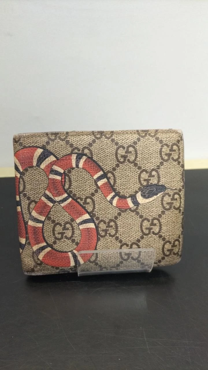 Portefeuille Gucci marron serpent état considération Gg / Suprême à deux volets