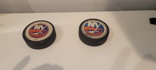 2 New York Islander Game Used Hockey Pucks Vintage Vegum and Canada