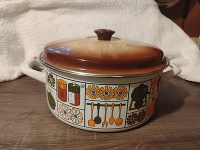 1970s enamelware Dutch oven with a retro kitchen graphics print and a brown lid.