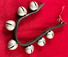 7 ANTIQUE PETAL SLEIGH BELLS (1.25” DIAMETER) ON LEATHER STRAP 1800’s