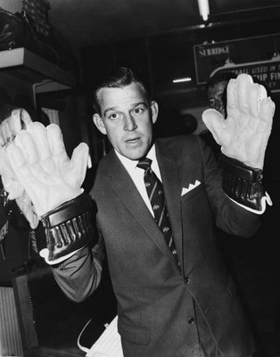 Australian wicket-keeper Wally Grout tries out pair keeper's gloves - Old Photo
