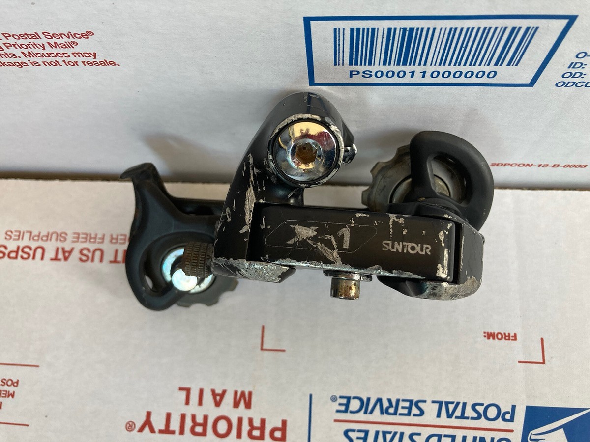Dérailleur Arrière VTT Suntour XCExpert Accushift Plus - 7 Vitesses - Cage Longue - Japon