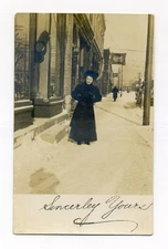 Oshkosh WI, woman on snowy street near Oshkosh beer sign, RPPC postcard