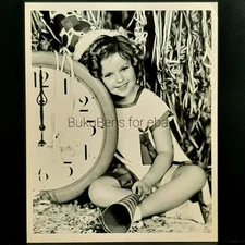1936 New Year's Portrait Photo of Shirley Temple Sitting Next to Giant Clock