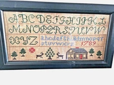 Wonderful Sampler featuring deer, trees and a Log Cabin Dated 1789?