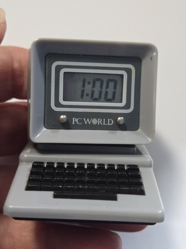 A desktop digital clock shaped like a mini PC from an 80s tech magazine promo — tiny, kitschy, and absurdly charming.