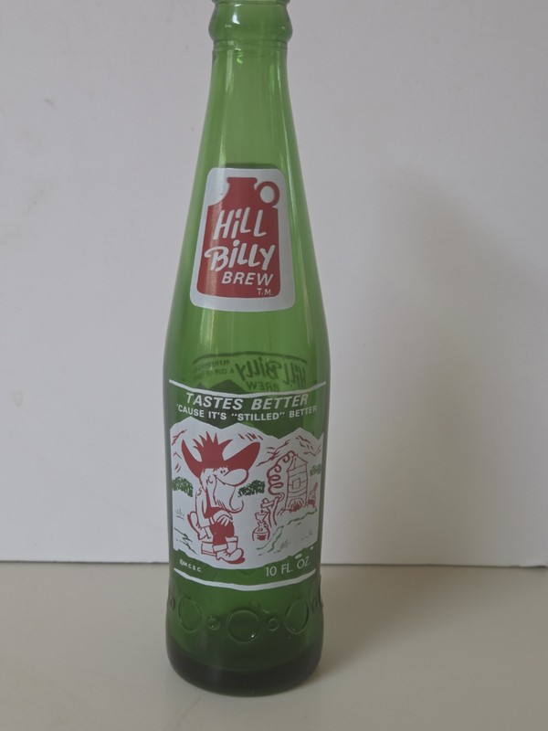 1965 vintage Soda POP Bottle: green 'LIL BROWN JUG w/ 2 HILLBILLY GRAPHICS  10oz