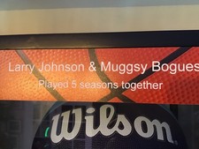 Autographed Larry Johnson and Muggsy Bogues, basketball and picture in a case