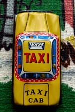 Vintage very tiny tin yellow taxi cab toy from Japan