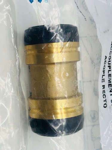 SharkBite 1-1/2 in. push-to-connect brass coupling fitting with black body and white label showing product details.