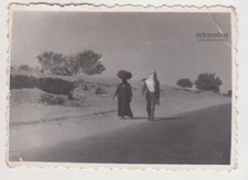 Two Arabs, Tradition Meets Modernity, Bravely Striding Through the Desert Photo