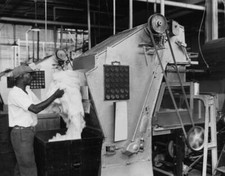 Worker operates a machine a factory making felt hats, Connecticut, Old Photo
