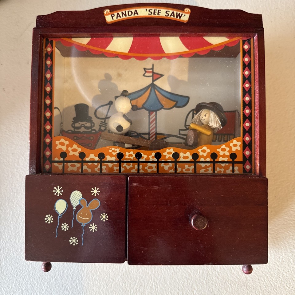A vintage Japanese animated wooden music box with pandas on a see-saw — whimsical circus-themed kinetic art you just don't find anymore.