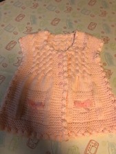 A gorgeous handmade cardigan for a little girl.