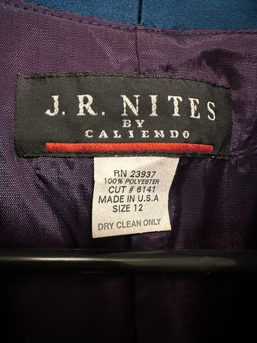 White fabric label on dark purple garment with red “J.R. Nites by Caliendo” text, product number RN23937, size 12.