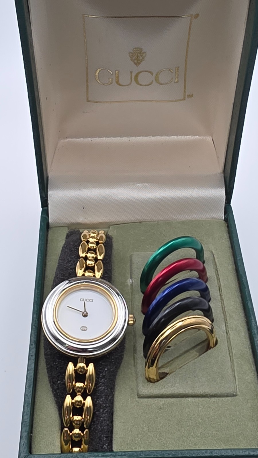 Gucci 1100L  Lady's Gold Plated Bracelet Watch with Six Interchangeable Bezels.