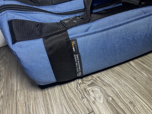 Blue Club Glove golf carry on duffel with black straps, side pocket, and white logo patch on textured fabric.