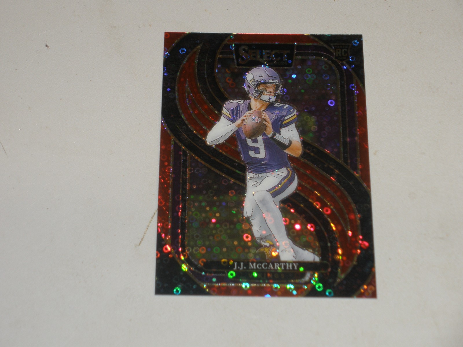 2024 Panini Select Premier Level Red Disco Prizm #134 JJ McCarthy 24/49 RC