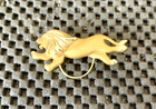 LION RUNNING AND JUMPING GOLD AND SILVER TONE PINBACK BROOCH 2" X 1" — photo 1
