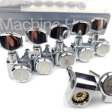 A set of 6 in-line screwless locking electric guitar tuners, chrome silver.