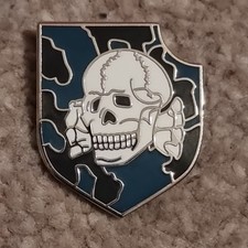 Skull on Camouflage in Shield Badge - 25mm high