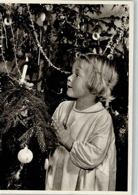 10550329 - Prayer of a Child Under the Decorated Christmas Tree Children