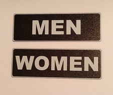 Men and Women Restroom Signs 3" X 9" Plastic w/Adhesive Strips New, Pkg has Both