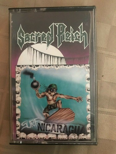 Sacred Reich *Surf Nicaragua *cassette *tape *Metal Blade *NM/VG+ *1988 *73359-4 - Afbeelding 1 van 6