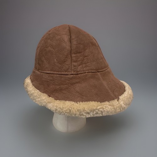 Brown suede vintage ranchero bucket hat with cream shearling lining and tan fabric brim, made in USA.