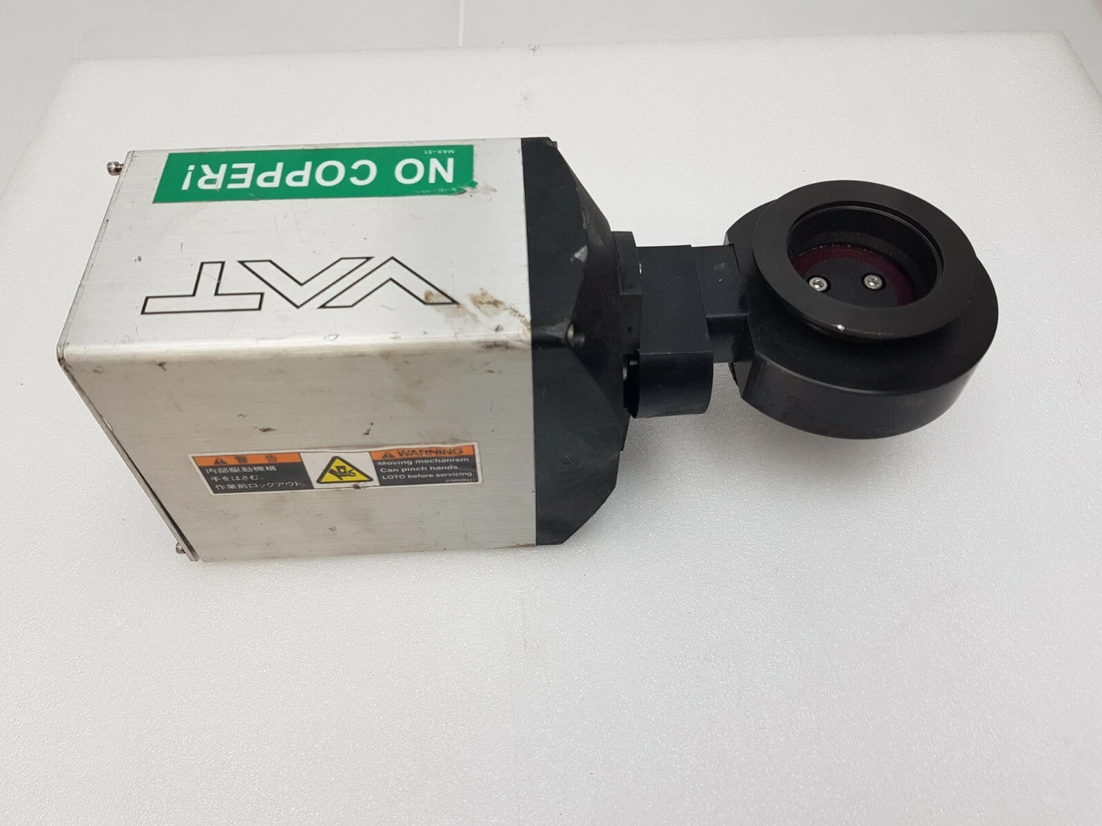 VAT Series 615 butterfly valve from above, showing the valve plate inside the flange and a NO COPPER label
