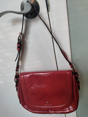 This is a vibrant red patent leather Kate Spade New York Piper Crossbody Bag...